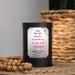 Black wax warmer with a personalized message on a textured surface with a woven basket in the background.