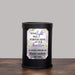 black wax melt warmer with floral design and memorial message with personalized name and years of life sitting on a wood table with a gray background