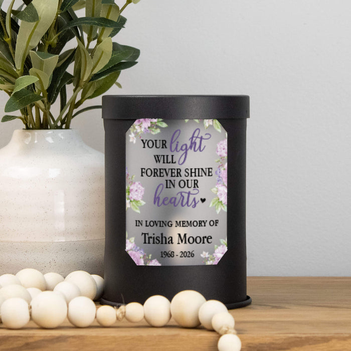 Memorial wax warmer with personalized message on a wooden surface with decorative elements.