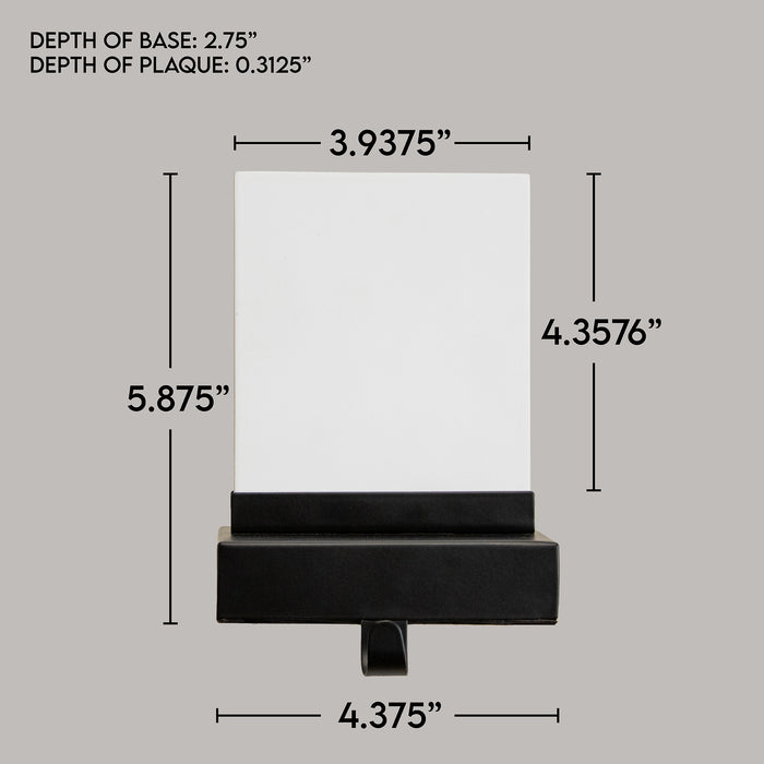 Product dimension diagram of a stocking holder plaque, showing measurements for depth of base (2.75"), plaque depth (0.3125"), and overall height (5.875") and width (4.375") on a light gray background.