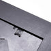 Close up of a black picture frame showing the hanger hook on a white background