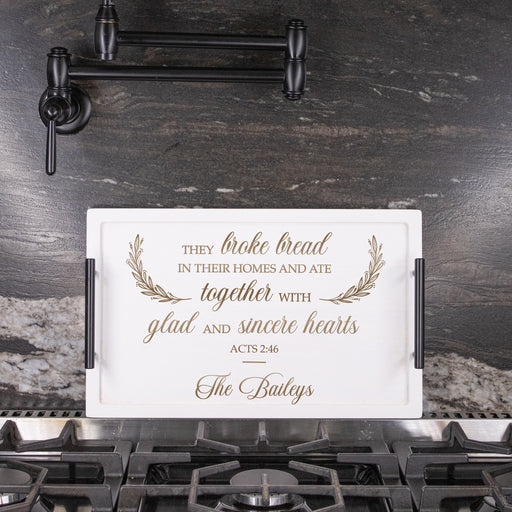 White serving tray personalized with family name engraved unfer acts 2:46 in a dark marble kitchen 