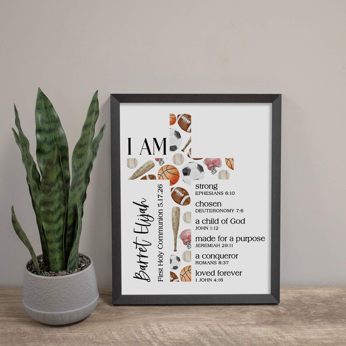 Framed motivational poster for first communion keepsake with religious text and symbols on a wooden surface with a plant.