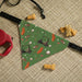 Dog bandana with golf-themed design on a textured surface with dog toys.