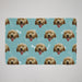 Patterned mat with repeated image of a dog's face on a blue background