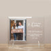 Personalized first home photo frame with a couple holding a 'home sweet home' sign, against a beige wall.