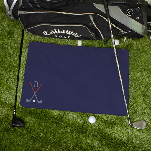 Monogrammed golf towel with golf bag on grass with golf clubs and balls