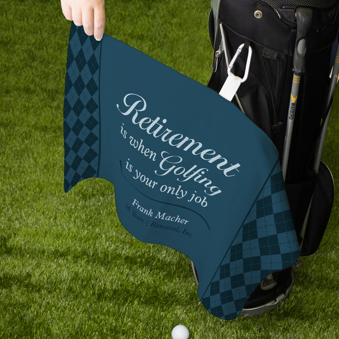 Hand holding out a retirement golf towel that is attached to a black golf bag
