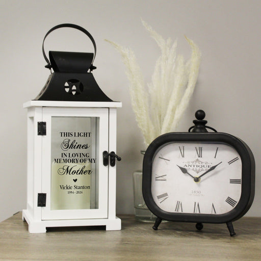 Black Mother Memorial Lantern on a table next to a black antique clock