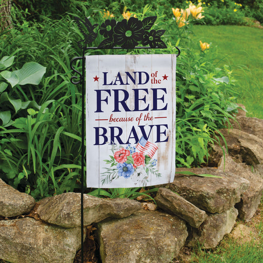 Patriotic garden flag with Land of The Free Because of the Brave quote  outside