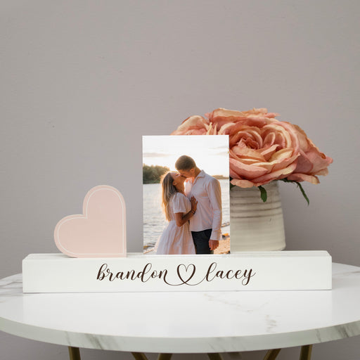 Personalized Photo Bar Engraved with Couple's Names on a table with flowers