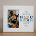 White picture frame with Baby's First Hanukkah 2025