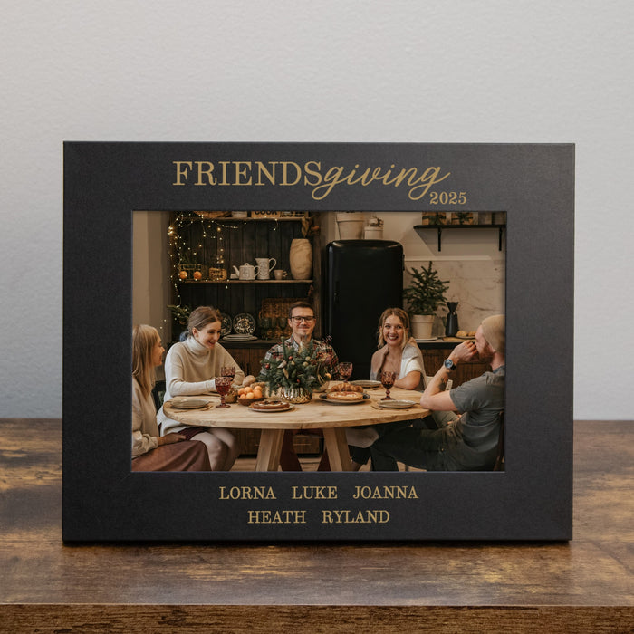 Personalized black frame with 'Friendsgiving' text containing a photo of people around a table.
