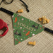 Personalized golf-themed dog bandana on a textured surface with dog toys.