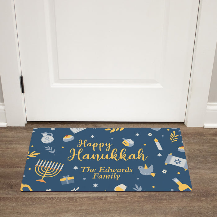 Personalized Happy Hanukkah doormat with family name on a wooden floor.