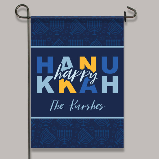 Garden flag with 'Happy Hanukkah' text on a blue background with menorah patterns.