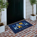 Personalized doormat with 'Happy Hanukkah' text on a brick porch