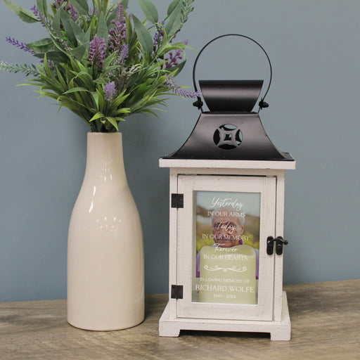 Personalized in memory of photo lantern on table next to vase of flowers
