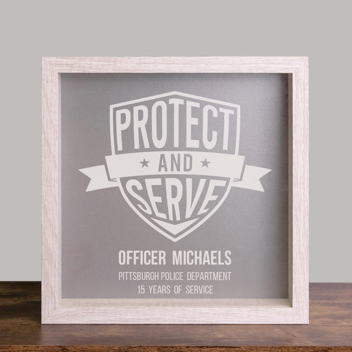 Framed shadow box with 'Protect and Serve' and personalized with officer's name