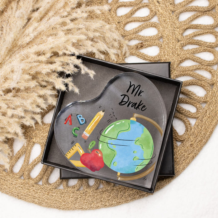 Decorative desktop sign with educational illustrations and teacher's name packaged inside a gift box