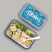 Bento box with under the sea design and food compartments and a personalized lid on a gray background