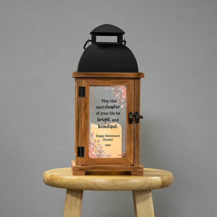 Wooden lantern with a floral retirement design on a gray background
