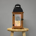 Wooden lantern with a floral retirement design on a gray background
