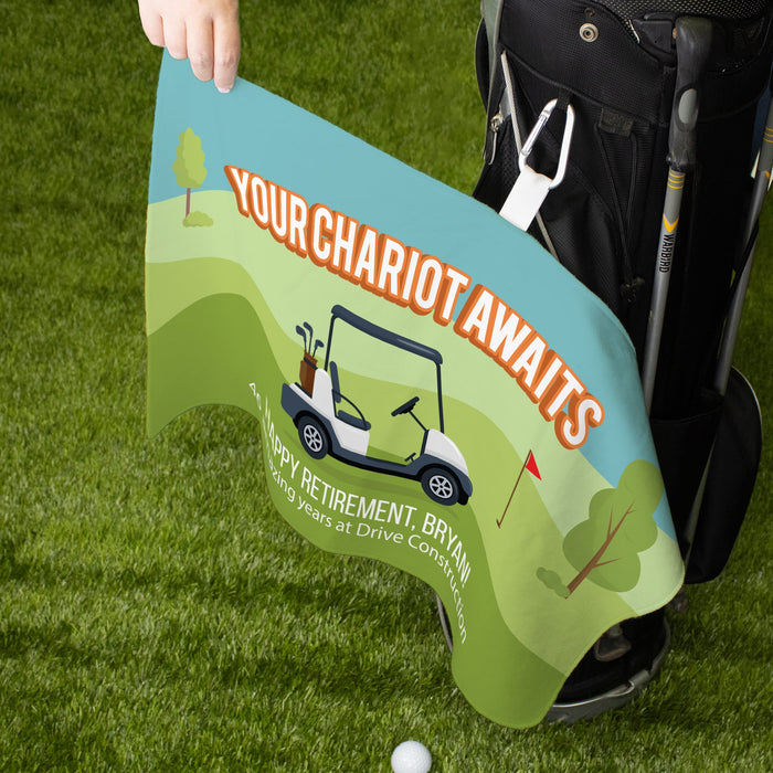 Personalized golf towel with 'Your Chariot Awaits' text and golf cart illustration on a golf course background.