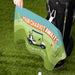 Personalized golf towel with 'Your Chariot Awaits' text and golf cart illustration on a golf course background.