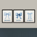 Three framed prints with blue bows and names on a gray wall.