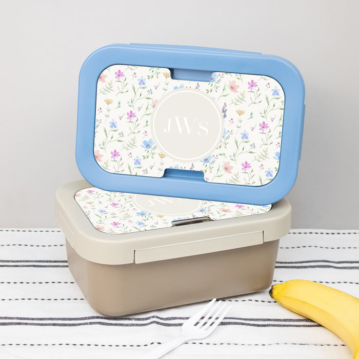 Blue and Tan Monogrammed Floral Lunch boxes stacked on a table