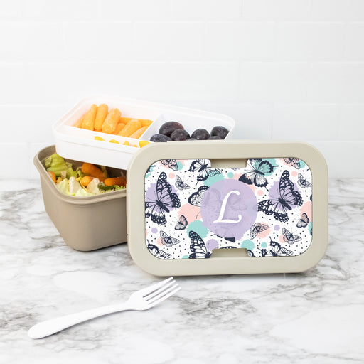 Bento box with custom butterfly pattern lid on a marble surface