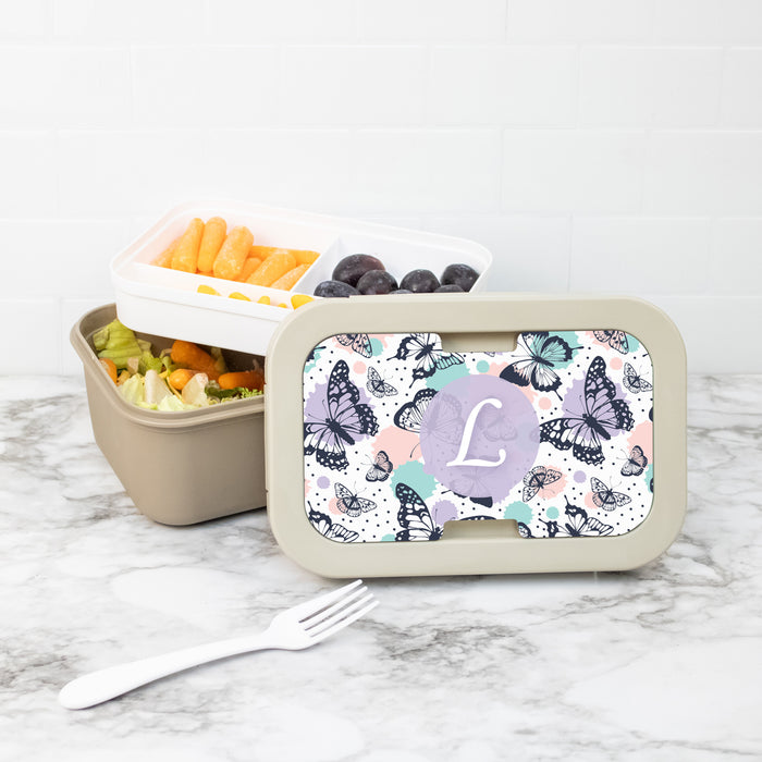 Bento box with custom butterfly pattern lid on a marble surface