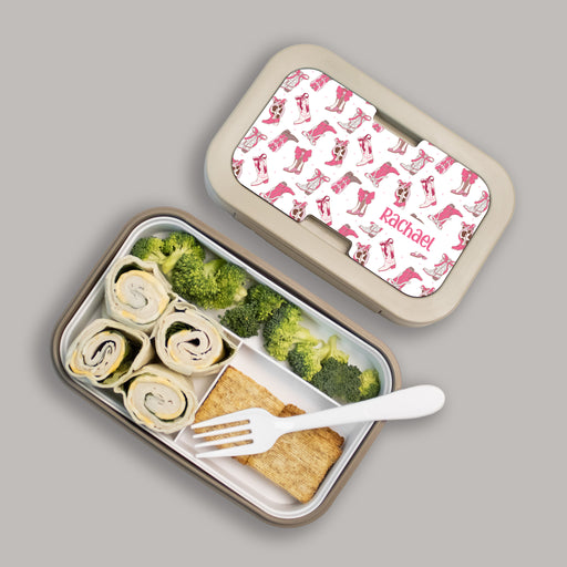Lunch box with compartments containing food and a fork, lid with cowgirl boots patterned design.