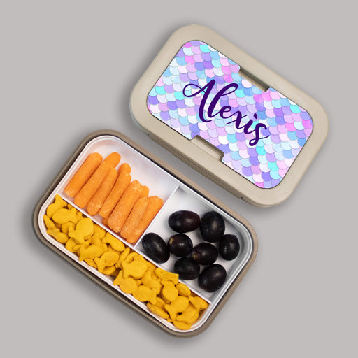 mermaid themed Bento box with compartments of snacks on a gray background