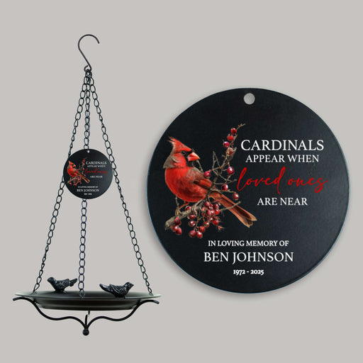 hanging bird bath with custom sail that reads cardinals appear when loved ones are near in front of a gray background