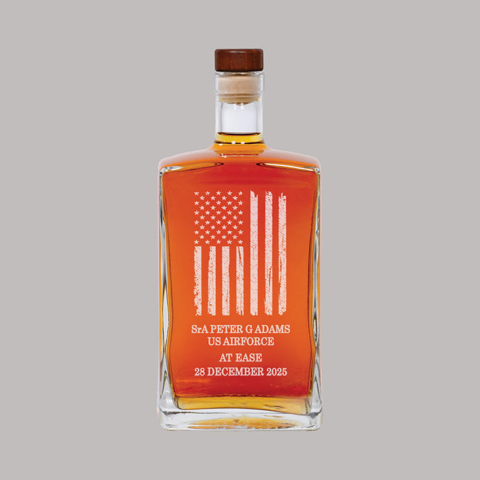 alcohol decanter with american flag engraved and retired military members information with a gray background