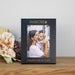 Personalized photo frame with 'dog MOM' text, holding a photo of a woman and dog, on a wooden surface with flowers.