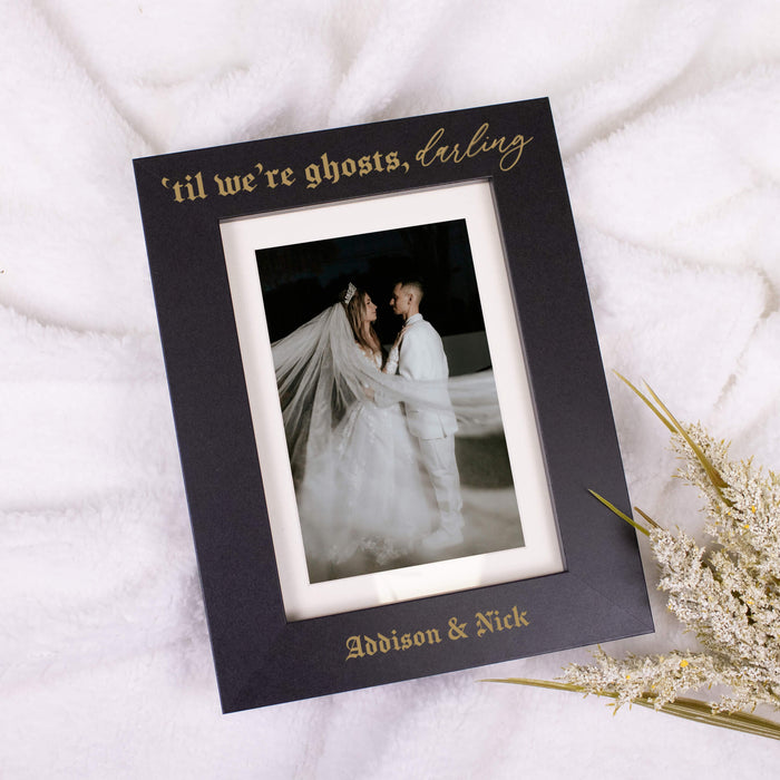 custom black engraved wooden frame that reads til we're ghosts darling and has couples names