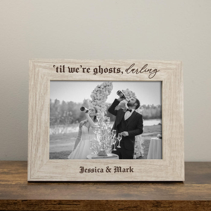 halloween or gothic wedding picture frame with engraved couples names in a rustic white