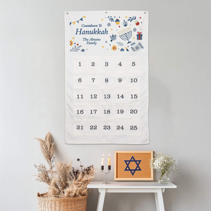 Hanukkah countdown calendar on a wall with decorative items below.