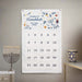 Hanukkah countdown calendar with decorative elements on a wall, next to a menorah and star of david decorative cup.