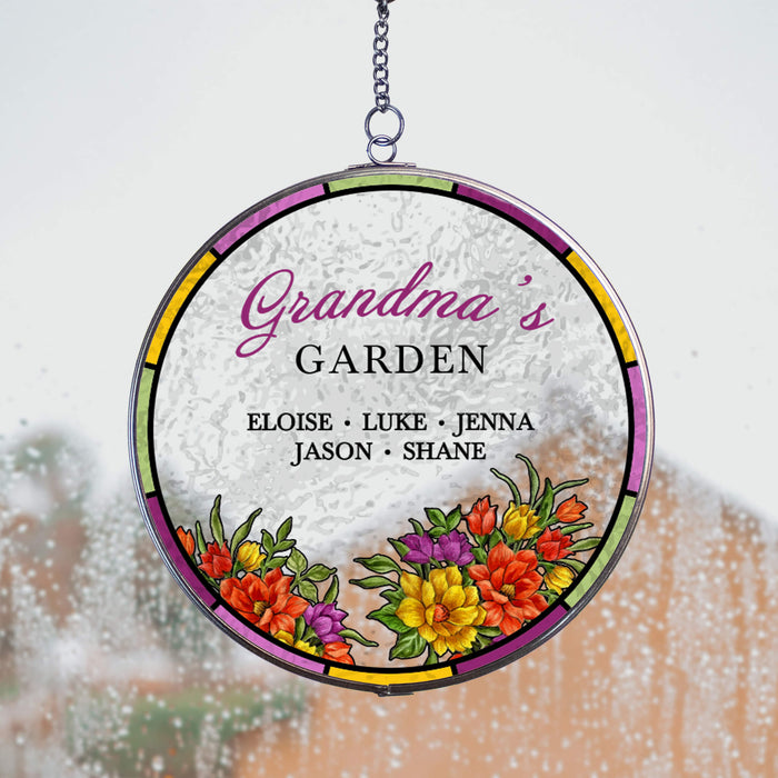 Round decorative hanging suncatcher with 'Grandma's Garden' and names, featuring colorful flowers on a window with rain