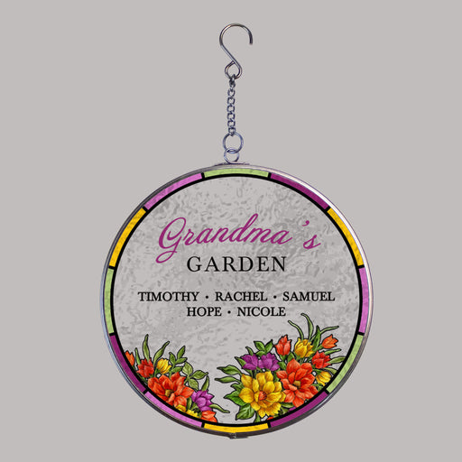 Round hanging suncatcher with floral design and text that reads "grandma's garden" on a gray background