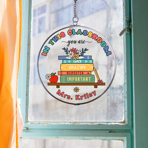 classroom decor suncatcher with affirmations for students hanging in a blue framed window with orange curtains