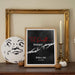 Framed artwork with 'Til Death Do Us Part' text and personalized name and wedding date on a shelf with decorative items