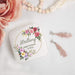 Personalized maid of honor jewelry box with floral design and text, accompanied by pink roses and tassel earrings.