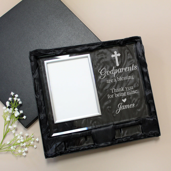 Glass picture frame engraved with a cross and "Godparents are a blessing" displayed inside of a satin-lined gift box